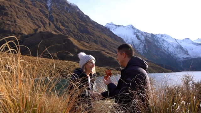Man proposes to fiance next to lake
